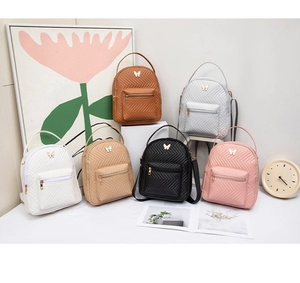 Detailed display of six colorful mini butterfly backpacks with quilted texture and metal decor