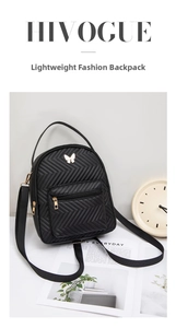 Close-up of black quilted mini backpack with a gold butterfly ornament and zipper pocket