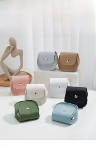 Close-up of semi-circle PU leather mini bags with gold metallic magnetic snap closure