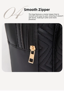 Detail of smooth gold zipper and quilted black PU leather on elegant crossbody bag