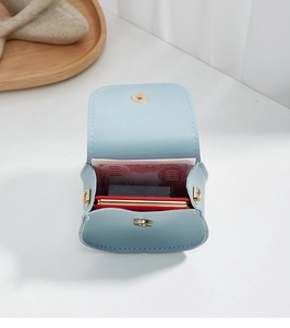 Internal view of mini light blue leather crossbody bag showing storage capacity
