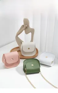 Top view of mini semi-circle crossbody bags in four colors with gold chain straps