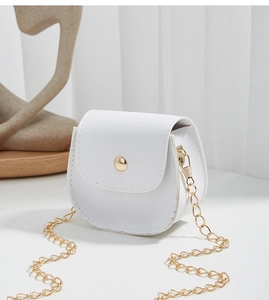 Detail of white mini crossbody bag with gold stud snap closure and textured finish