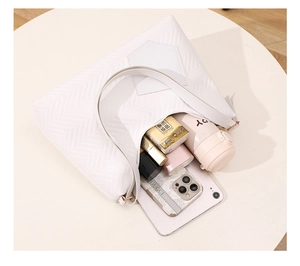 White minimalist tote bag with herringbone stitching showing large interior capacity