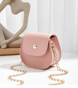 Detailed shot of a mini pink half-round crossbody bag with golden chain and metal clasp