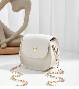 Close-up of white pebble grain mini crossbody bag with gold hardware and chain strap
