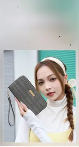 Close-up of women's herringbone pattern long wallet with gold plate and wrist strap