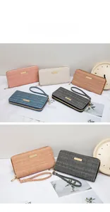 Detail view of long sequin wallets in five colors with wristlets and metal decoration