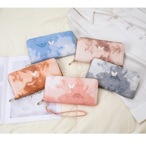 Flat lay of five marble pattern zip wallets in various colors with butterfly metal icons