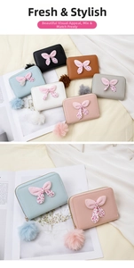 Close-up of colorful PU leather mini purses with bow knots and plush pom-poms