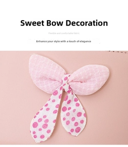 Detail of pink polka dot bow charm with textured mesh fabric on a small coin purse