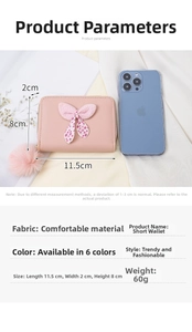 Pink mini wallet with polka dot bow and dimensions 11.5x8x2cm shown with accessories
