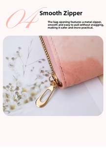 Close-up of smooth gold metal zipper and pink matte leather texture on clutch bag