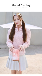 Close-up of pink gradient marble pattern wallet with butterfly emblem and wrist strap