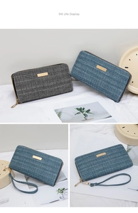 Detail of herringbone woven long wallets in grey and blue with golden metal plates