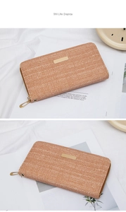 Detail of herringbone fabric wallet with a rectangular gold metal plaque on the front