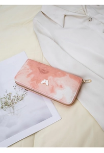 Close-up of a pink marble pattern wallet featuring a golden zipper and butterfly buckle