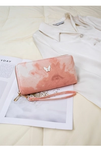 Detail of pink marble gradient wallet with elegant butterfly ornament and wrist strap