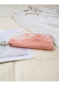 Close-up of pink marble texture clutch featuring a white butterfly emblem and gold zipper