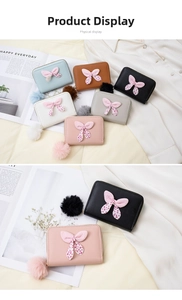 Detail of macaron-colored coin purses with polka dot bows and soft pom-pom charms