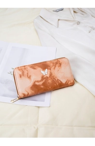 Detail of long zipper wallet featuring marble gradient pattern and butterfly emblem