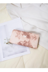 Detail of a pink marble texture zip wallet with a white butterfly metal logo on it