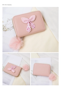 Detailed views of pink polka dot bow purse with a soft fluffy pompom keychain detail