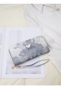 Detail of marble pattern long wallet for women with elegant white butterfly hardware