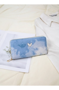 Detail of long blue and white cloud dye wallet with butterfly logo and gold zipper
