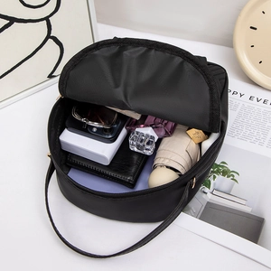 Minimalist black solid color nylon backpack with butterfly detail and high capacity interior