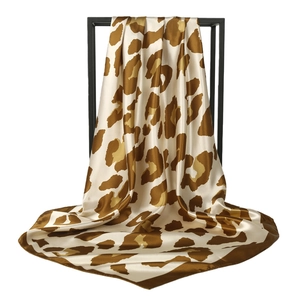 Classic leopard print satin silk scarf 90cm square wrap displayed on a minimalist stand