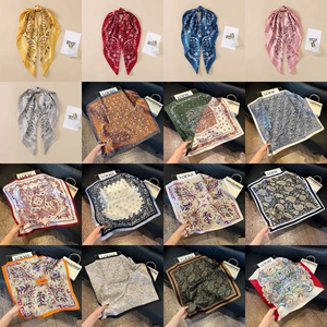 Multiple paisley silk scarves in various colors with elegant satin finish and patterns