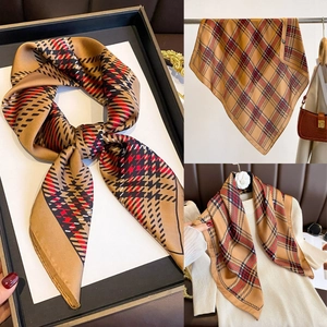 Detail of classic khaki plaid silk square scarf with soft texture and refined stitching