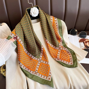 Elegant French style plaid silk scarf in olive green and orange on a chic outfit