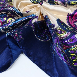 Détail d'un foulard en satin imprimé paisley avec texture lisse et bords surpiqués