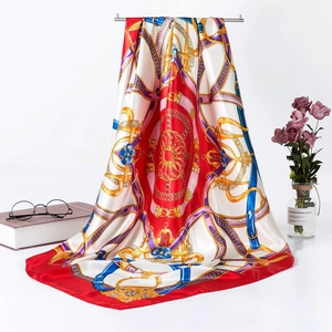 Detail of red and cream silk satin scarf with equestrian chain print and smooth drape