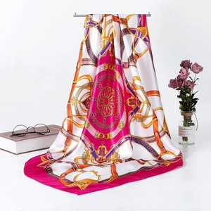 Detail of luxury 90cm square silk scarf featuring chain print and equestrian motifs
