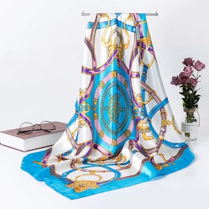 Detail of 90cm silk scarf featuring classic golden chain and leather strap prints