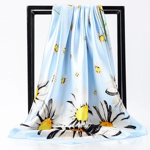 Detail of silk-like satin square scarf with white daisy print on sky blue background