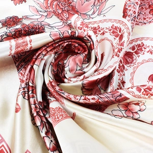 Detail of silk scarf showing glossy texture and elegant red peony floral print