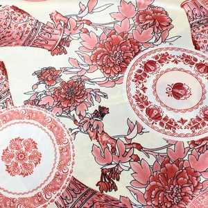 Detailed macro view of oriental floral patterns and porcelain motifs on silk fabric