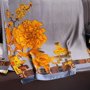 Detail of silver silk scarf featuring gold floral patterns and traditional Chinese motifs