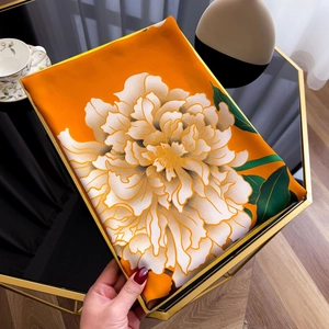Elegant orange silk scarf with large white peony flowers and golden hem details