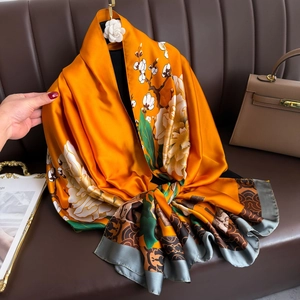 Elegant orange silk scarf with floral peony patterns and glossy satin finish for women