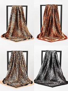 Macro view of leopard print silk scarves in four elegant tones with satin finish