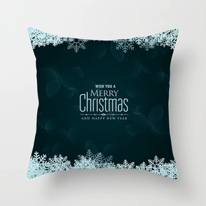 Detail of dark green Christmas pillowcase with white holiday text and snowflake patterns