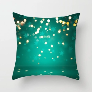 Close-up of green Christmas pillowcase with blue snowflake and glowing polka dot print