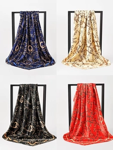 Detail view of 90cm silk scarves with luxury gold chain patterns and Paris lettering