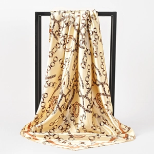 90cm silk scarf with champagne gold chain print and Paris motif on a display stand