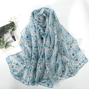 Blue paisley print voile scarf with tassels for sun protection and autumn warmth